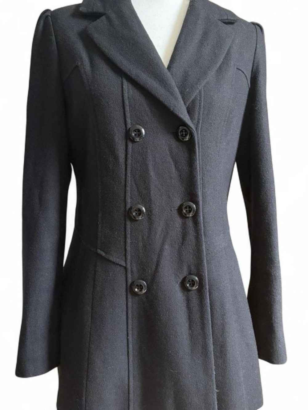 Black wool coat with double breasted buttons and pleated skirt